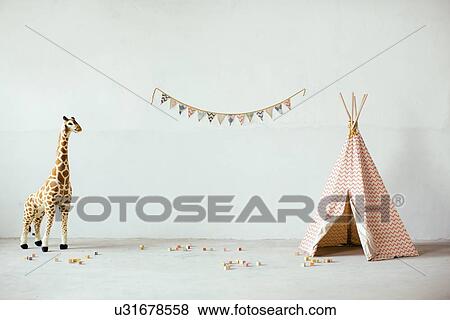 "Still life with toy giraffe, teepee and bunting" View Large Photo Image Stock Photo - "Still life with toy giraffe, teepee and bunting". Fotosearch