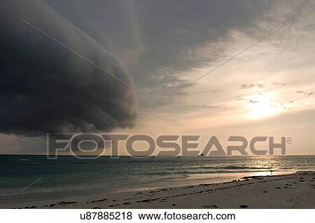 Stock Photo - "Storm clouds forming on coast of Perez Island at sunset, Gulf of Mexico". Fotosearch