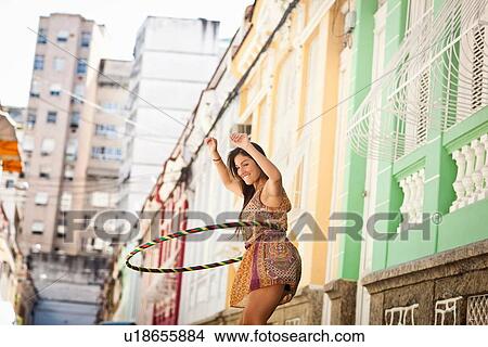 Picture - "Student celebrating, demonstrating hula hoop skills in the street, Rio de Janeiro, Brazil". Fotosearch