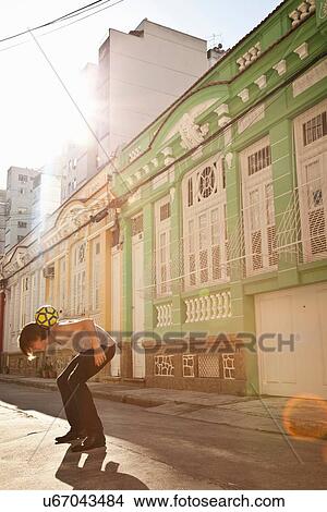 Picture - "Student celebrating with football skills in the street, Rio de Janeiro, Brazil". Fotosearch
