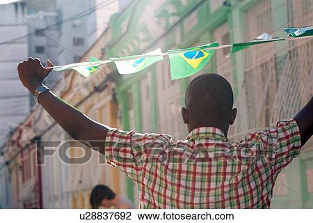 Stock Image - "Students celebrating with Brazilian flags in the street, Rio de Janeiro, Brazil". Fotosearch