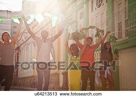 Stock Image - "Students celebrating with Brazilian flags in the street, Rio de Janeiro, Brazil". Fotosearch