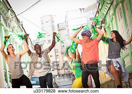 Stock Photo - "Students celebrating with Brazilian flags in the street, Rio de Janeiro, Brazil". Fotosearch