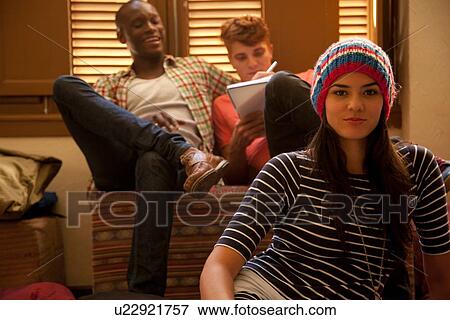 Students chilling out and studying in living room View Large Photo Image Stock Photo - Students chilling out and studying in living room. Fotosearch