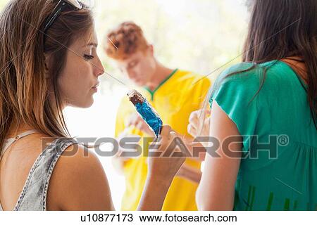 Students having ice lollies View Large Photo Image Stock Image - Students having ice lollies. Fotosearch