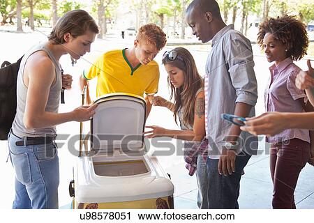 Stock Image - Students having ice lollies. Fotosearch