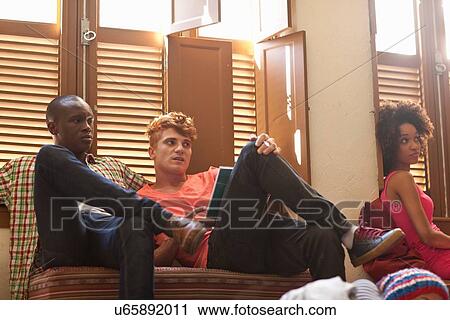 Students relaxing in living room View Large Photo Image Stock Image - Students relaxing in living room. Fotosearch