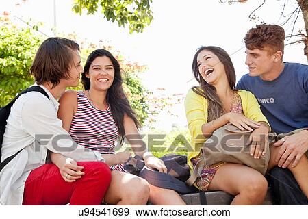 Stock Photo - Students sitting under tree. Fotosearch