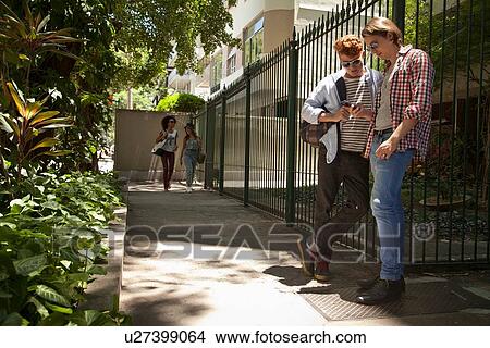 Students standing by railings View Large Photo Image Picture - Students standing by railings. Fotosearch