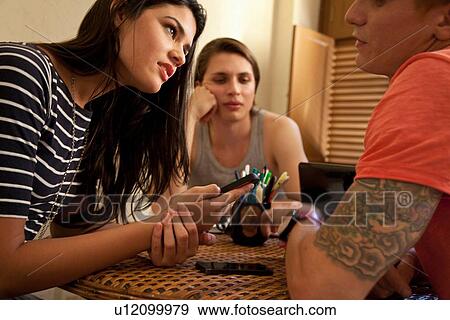 Students using smartphone and relaxing View Large Photo Image Stock Photo - Students using smartphone and relaxing. Fotosearch