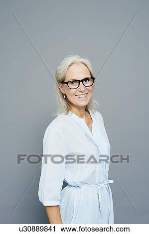 Studio portrait of smiling mature businesswoman View Large Photo Image Stock Image - Studio portrait of smiling mature businesswoman. Fotosearch