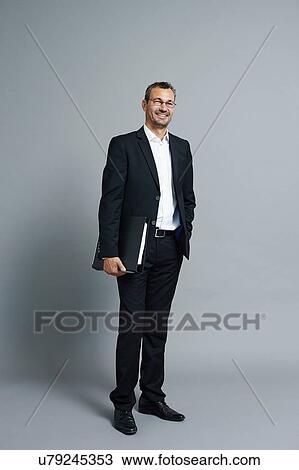 Studio portrait of smiling mature businessman View Large Photo Image Stock Image - Studio portrait of smiling mature businessman. Fotosearch