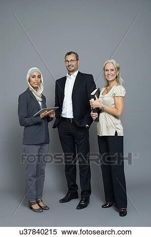 Studio portrait of two businesswomen and businessman View Large Photo Image Stock Photography - Studio portrait of two businesswomen and businessman. Fotosearch