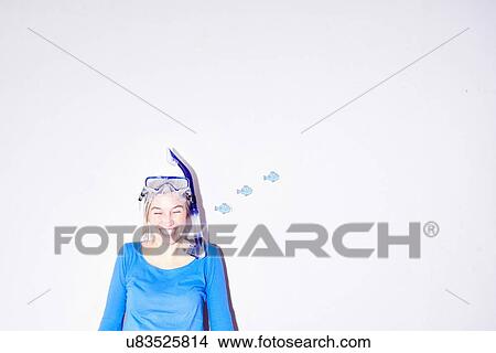 Picture - Studio portrait of young woman wearing goggles and snorkel mask. Fotosearch