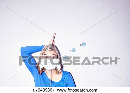 Studio shot of young woman with hand on head holding up drawing of sharks mouth View Large Photo Image Stock Photo - Studio shot of young woman with hand on head holding up drawing of sharks mouth. Fotosearch