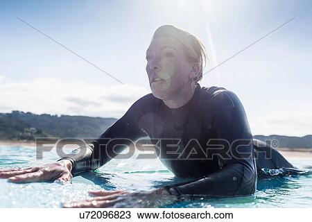 Stock Image - "Surfer in the water, Bay of Islands, NZ". Fotosearch