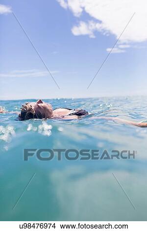 Swimmer floating in sea View Large Photo Image Picture - Swimmer floating in sea. Fotosearch
