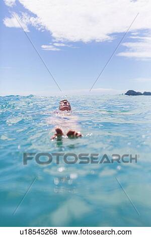 Swimmer floating the water View Large Photo Image Stock Photo - Swimmer floating the water. Fotosearch