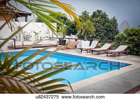Stock Photography - "Swimming pool on terrace, Sugarloaf Mountain in background, Rio, Brazil". Fotosearch