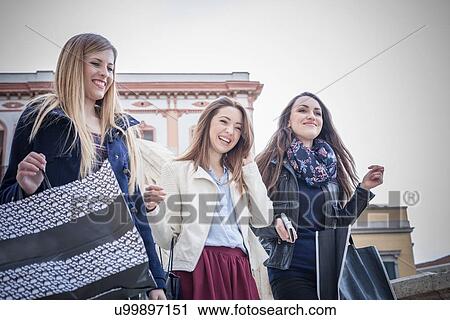 "Three female friends carrying shopping bags, Cagliari, Sardinia, Italy" View Large Photo Image Stock Image - "Three female friends carrying shopping bags, Cagliari, Sardinia, Italy". Fotosearch
