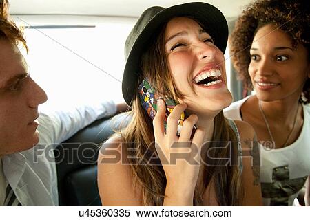 "Three friends in car, woman on cell phone" View Large Photo Image Stock Photography - "Three friends in car, woman on cell phone". Fotosearch