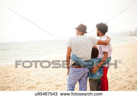 Stock Image - "Three generation family enjoying beach, Rio de Janeiro, Brazil". Fotosearch