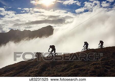 "Three people mountain biking, Valais, Switzerland" View Large Photo Image Stock Photography - "Three people mountain biking, Valais, Switzerland". Fotosearch