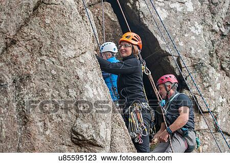Three rock climbers on cliff View Large Photo Image Stock Image - Three rock climbers on cliff. Fotosearch