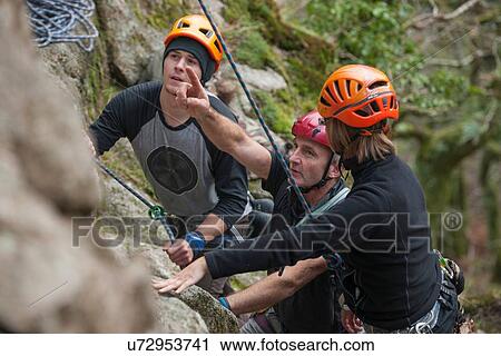 Three rock climbers planning route View Large Photo Image Stock Image - Three rock climbers planning route. Fotosearch
