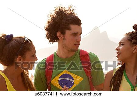 "Three young adult friends chatting on Ipanema beach, Rio De Janeiro, Brazil" View Large Photo Image Stock Image - "Three young adult friends chatting on Ipanema beach, Rio De Janeiro, Brazil". Fotosearch