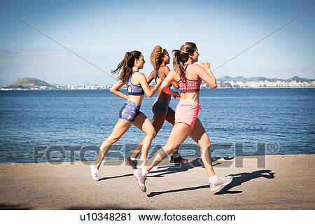 Three young women jogging on beach View Large Photo Image Stock Image - Three young women jogging on beach. Fotosearch