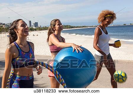 Three young women on beach with fitness ball View Large Photo Image Stock Image - Three young women on beach with fitness ball. Fotosearch
