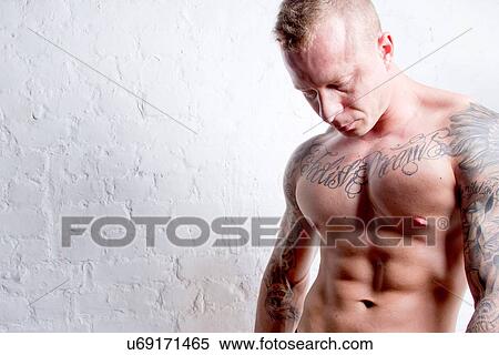 Topless young man with tattoos View Large Photo Image Stock Photography - Topless young man with tattoos. Fotosearch