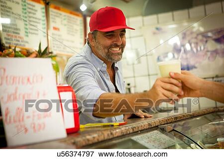 Stock Photo - "Tourist buying smoothie in juice bar, Copacabana town, Rio De Janeiro, Brazil". Fotosearch