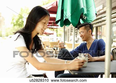 "Tourist couple at sidewalk cafe reading smartphones messages, The Bund, Shanghai, China" View Large Photo Image Stock Image - "Tourist couple at sidewalk cafe reading smartphones messages, The Bund, Shanghai, China". Fotosearch