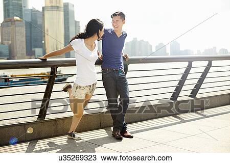 "Tourist couple chatting on bridge, The Bund, Shanghai, China" View Large Photo Image Stock Image - "Tourist couple chatting on bridge, The Bund, Shanghai, China". Fotosearch