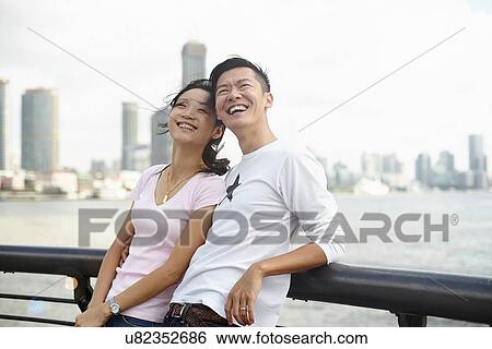 "Tourist couple leaning against bridge railing looking up, The Bund, Shanghai, China" View Large Photo Image Stock Photograph - "Tourist couple leaning against bridge railing looking up, The Bund, Shanghai, China". Fotosearch
