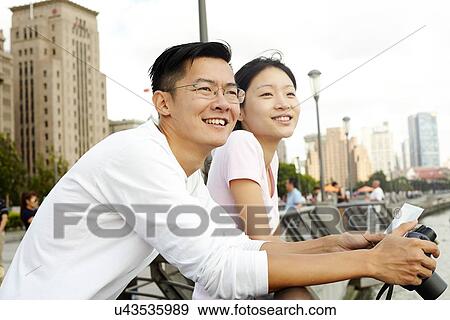 "Tourist couple looking out at view with instant camera, The Bund, Shanghai, China" View Large Photo Image Stock Photo - "Tourist couple looking out at view with instant camera, The Bund, Shanghai, China". Fotosearch