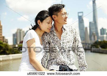 "Tourist couple sitting on wall, The Bund, Shanghai, China" View Large Photo Image Stock Image - "Tourist couple sitting on wall, The Bund, Shanghai, China". Fotosearch