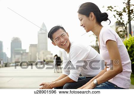 "Tourist couple sitting on wall, The Bund, Shanghai, China" View Large Photo Image Stock Photograph - "Tourist couple sitting on wall, The Bund, Shanghai, China". Fotosearch