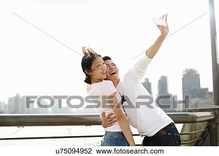 "Tourist couple taking smartphone selfie, The Bund, Shanghai, China" View Large Photo Image Stock Image - "Tourist couple taking smartphone selfie, The Bund, Shanghai, China". Fotosearch