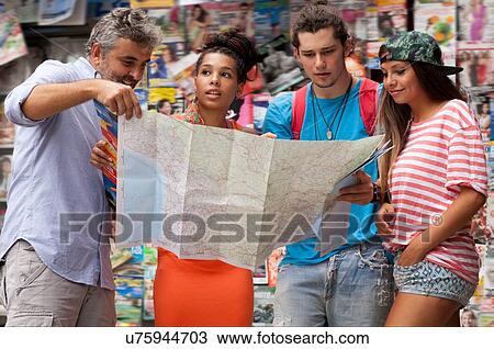 Stock Image - "Tourist friends reading map, Copacabana town, Rio De Janeiro, Brazil". Fotosearch