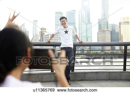 "Tourist posing for girlfriend with instant camera, The Bund, Shanghai, China" View Large Photo Image Stock Photo - "Tourist posing for girlfriend with instant camera, The Bund, Shanghai, China". Fotosearch