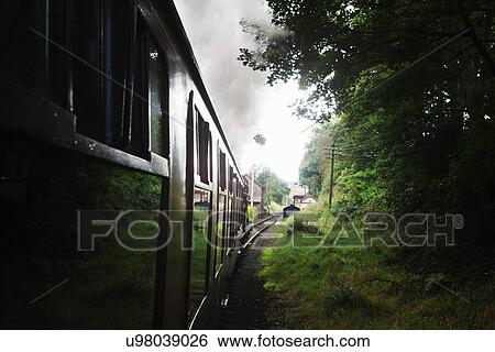 Stock Photograph - "Train moving along tracks, close-up". Fotosearch