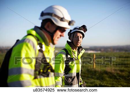 "Two engineers at wind farm, walking together" View Large Photo Image Stock Photography - "Two engineers at wind farm, walking together". Fotosearch
