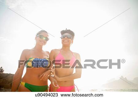 "Two female friends wearing bikini bottoms strolling on Ipanema beach, Rio De Janeiro, Brazil" View Large Photo Image Stock Image - "Two female friends wearing bikini bottoms strolling on Ipanema beach, Rio De Janeiro, Brazil". Fotosearch