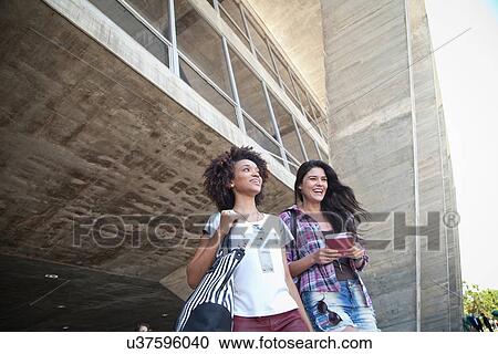 Two female students outside building View Large Photo Image Stock Image - Two female students outside building. Fotosearch