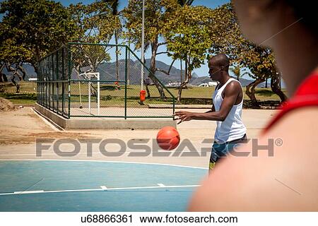 Two male basketball players on basketball court View Large Photo Image Stock Image - Two male basketball players on basketball court. Fotosearch
