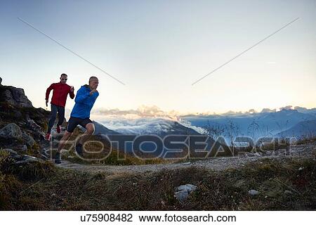 "Two mature men trail running, Valais, Switzerland" View Large Photo Image Stock Image - "Two mature men trail running, Valais, Switzerland". Fotosearch
