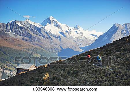 Stock Photo - "Two mountain bikers, Valais, Switzerland". Fotosearch